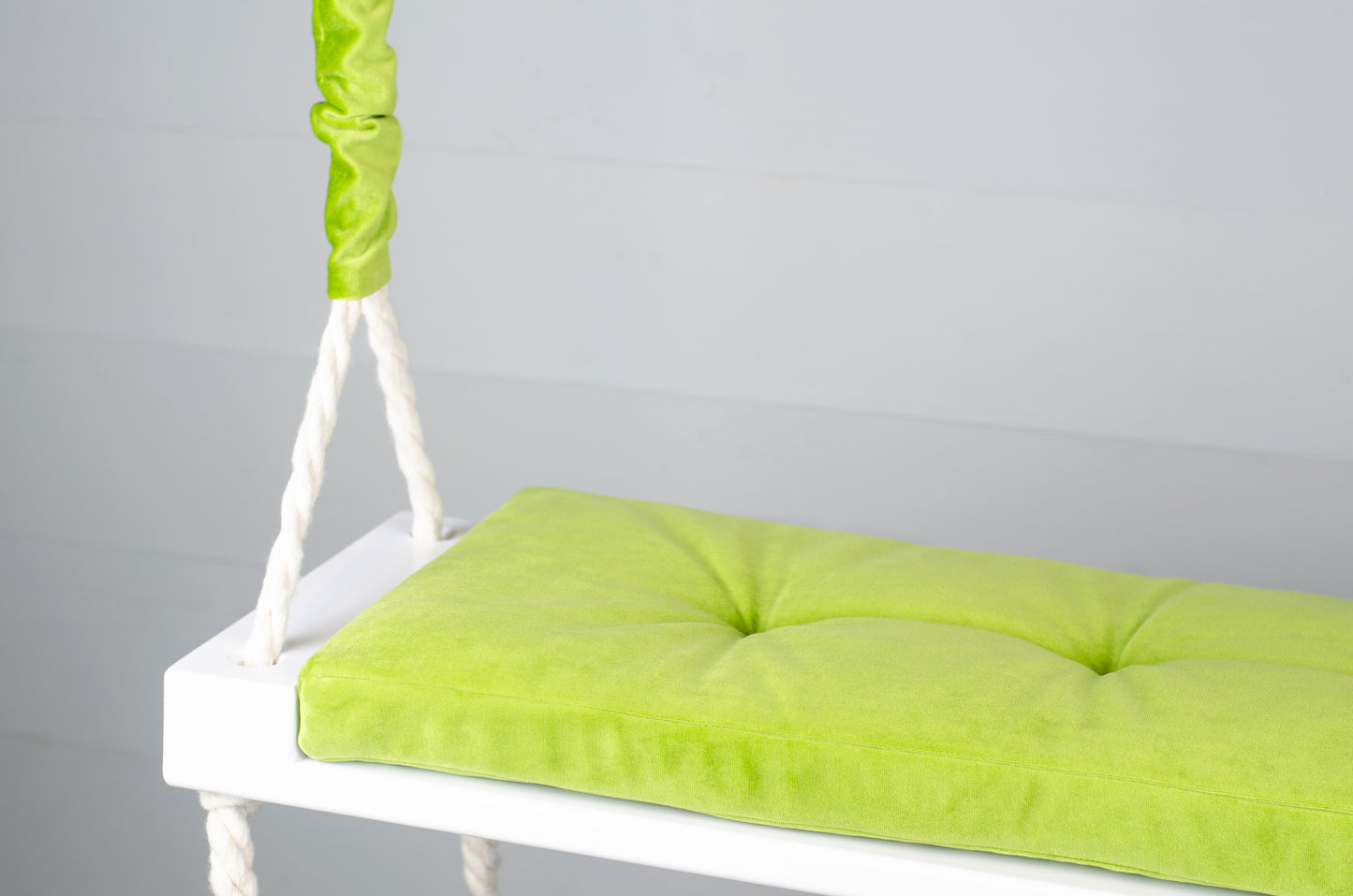 Adult Inside White Swing With A Green Seat