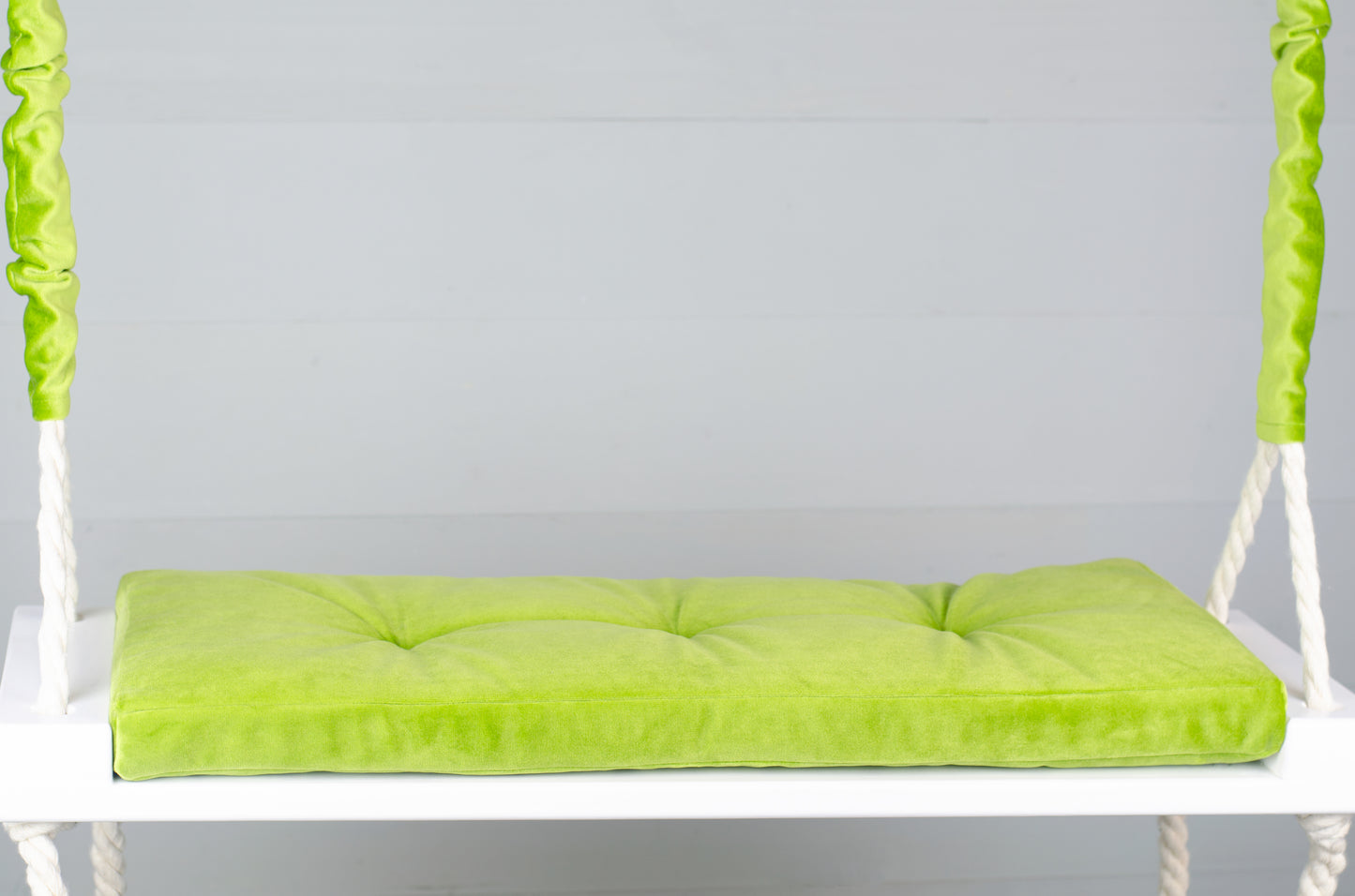 Adult Inside White Swing With A Green Seat