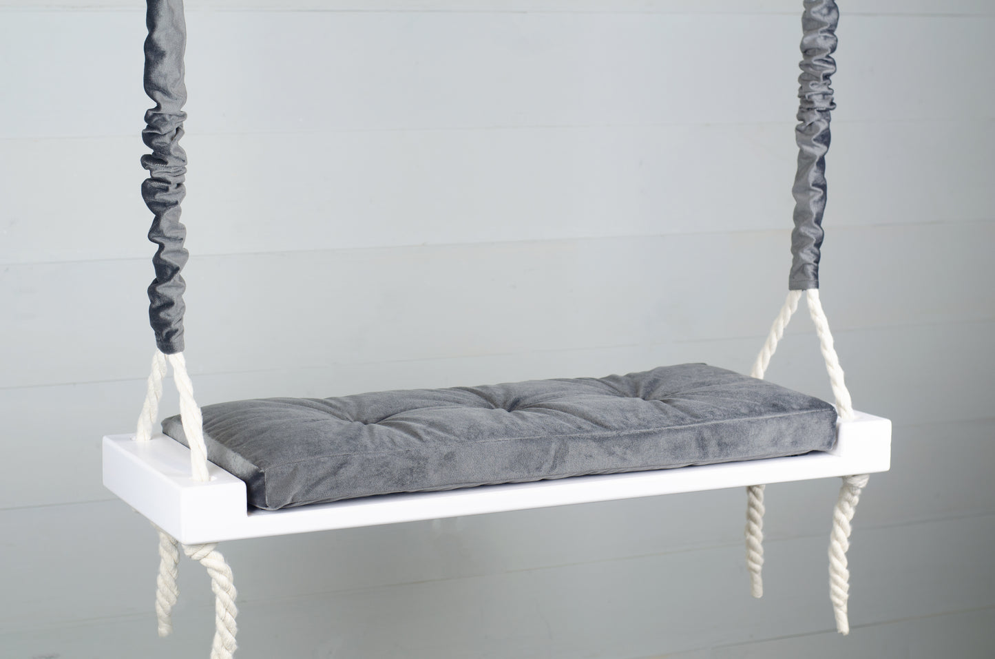 Adult Inside White Swing With A Gray Seat
