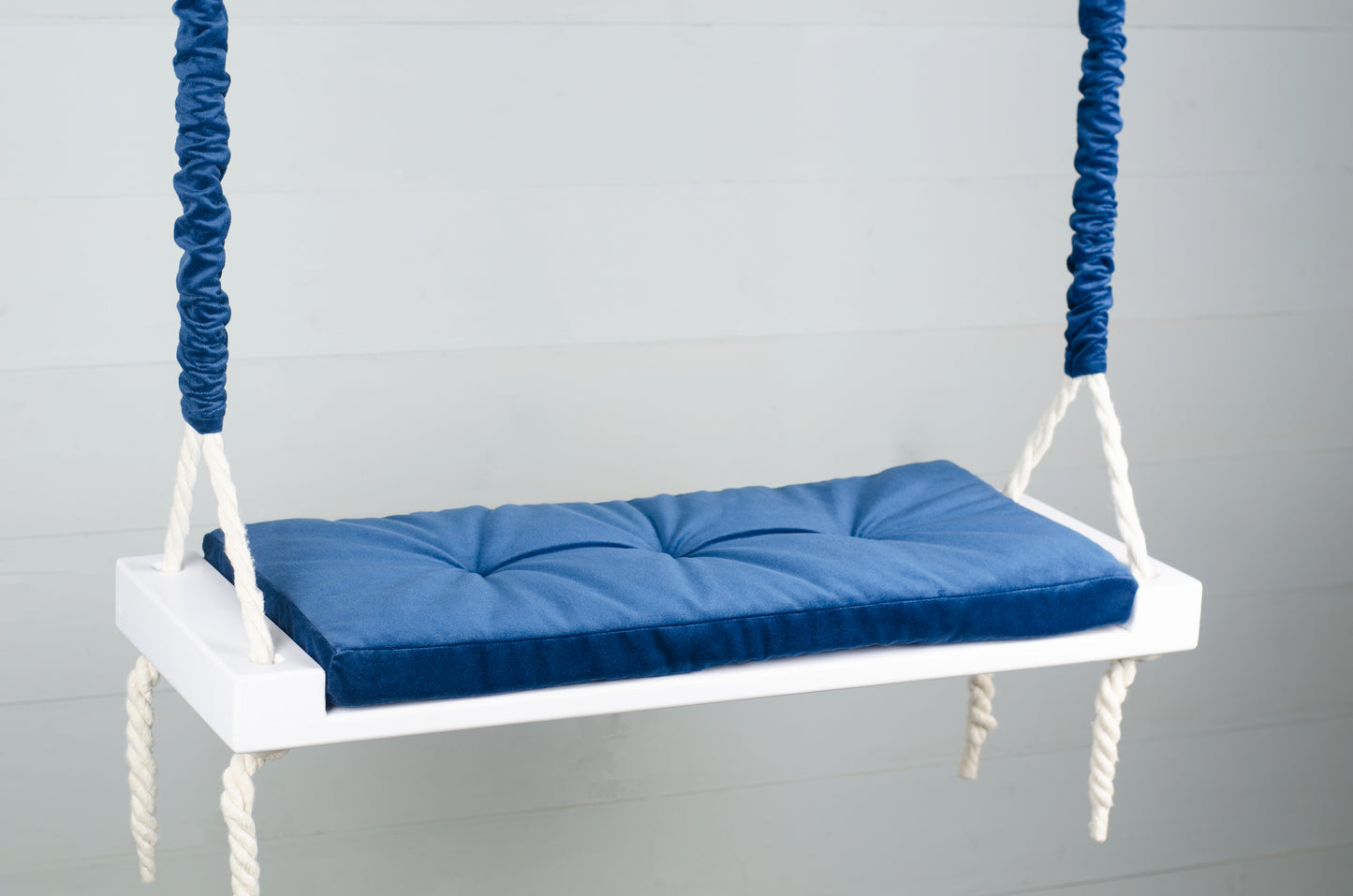 Adult Inside White Swing With A Blue Seat