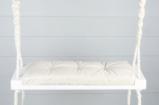 Adult Inside White Swing With A Beige Seat