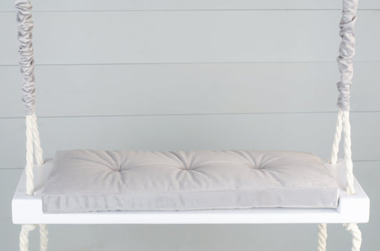 Adult Inside White Swing With A Gray Seat