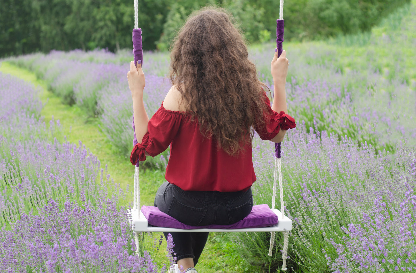 Adult Inside White Swing With A Purple Seat
