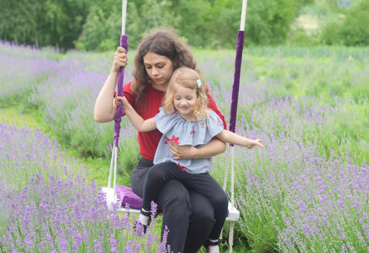 Adult Inside White Swing With A Purple Seat