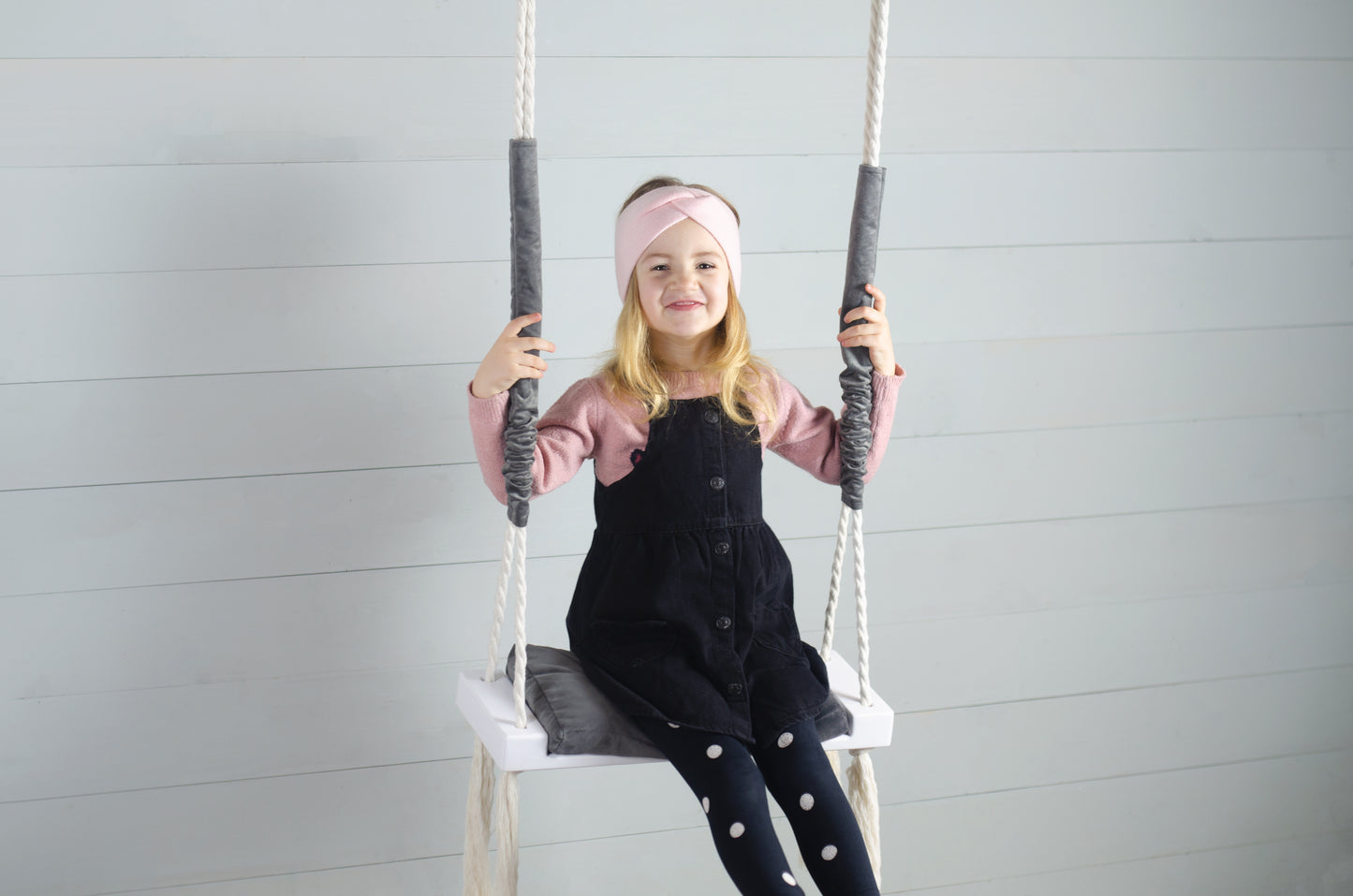 Children Inside White Swing With A Gray Seat