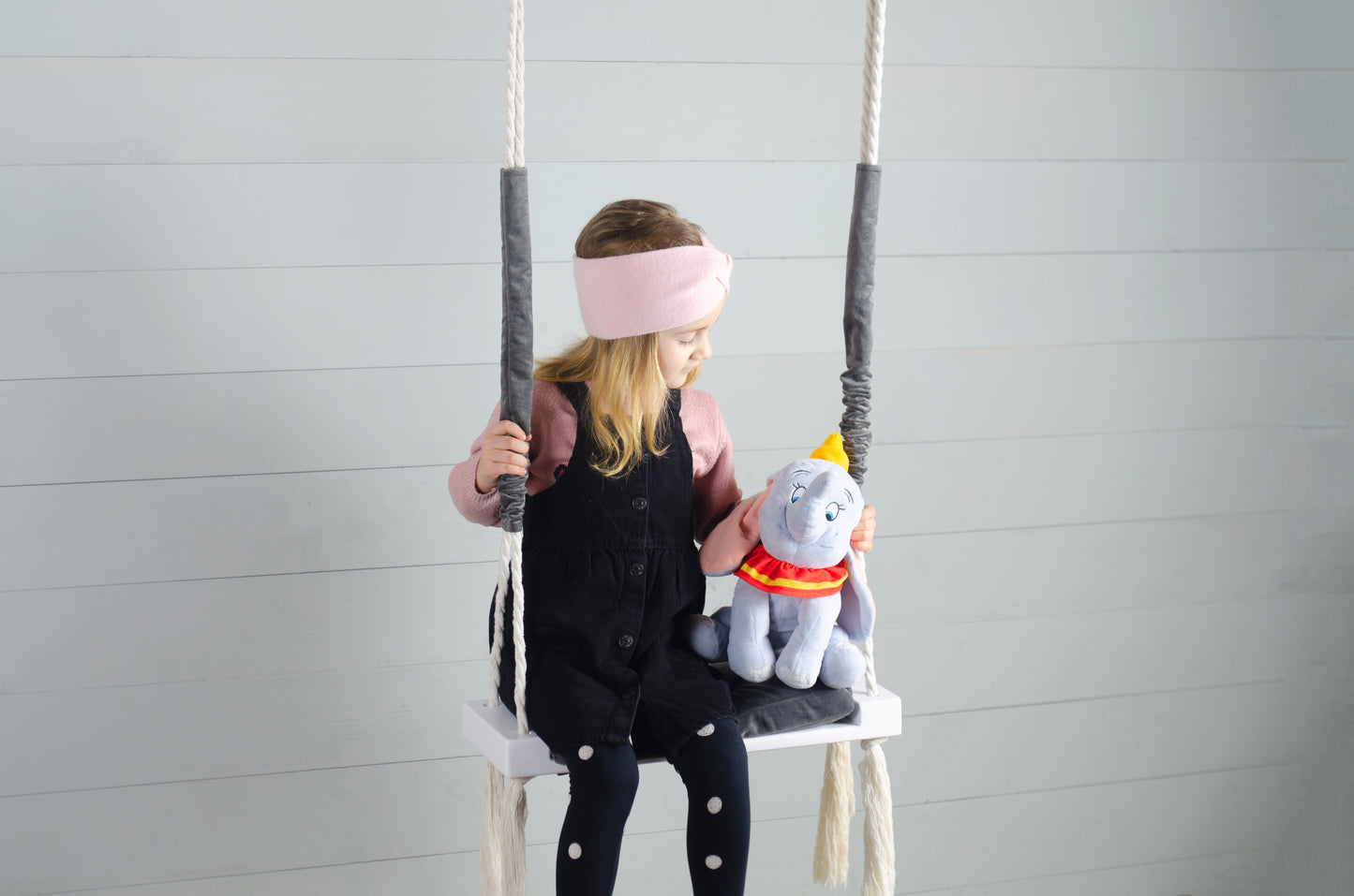 Children Inside White Swing With A Gray Seat