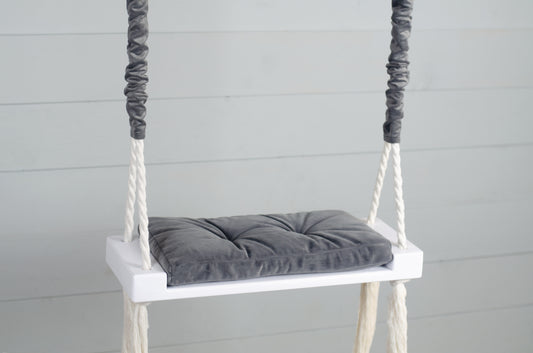 Children Inside White Swing With A Gray Seat