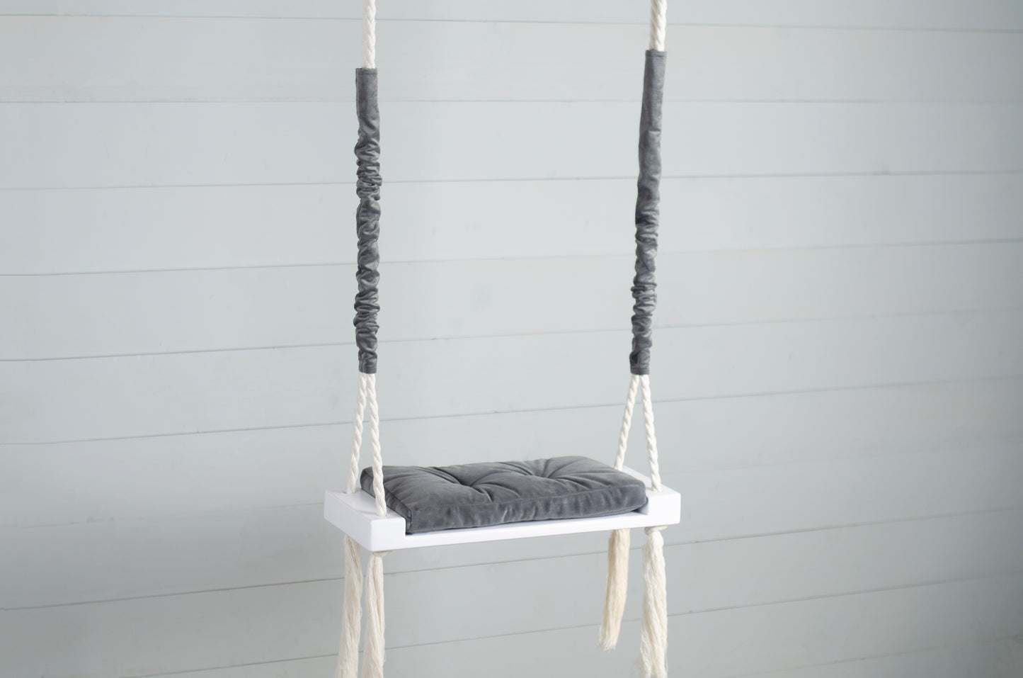 Children Inside White Swing With A Gray Seat
