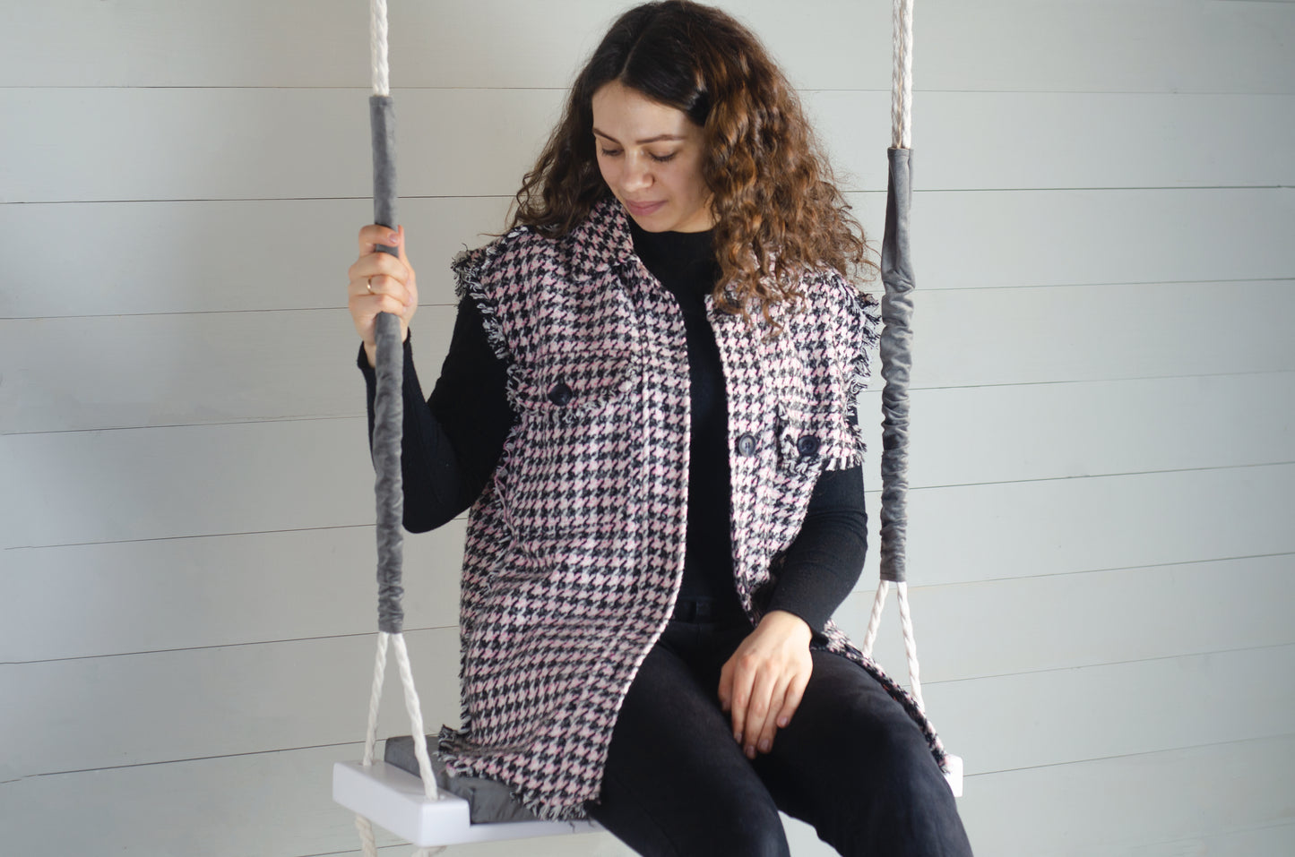 Adult Inside White Swing With A Gray Seat
