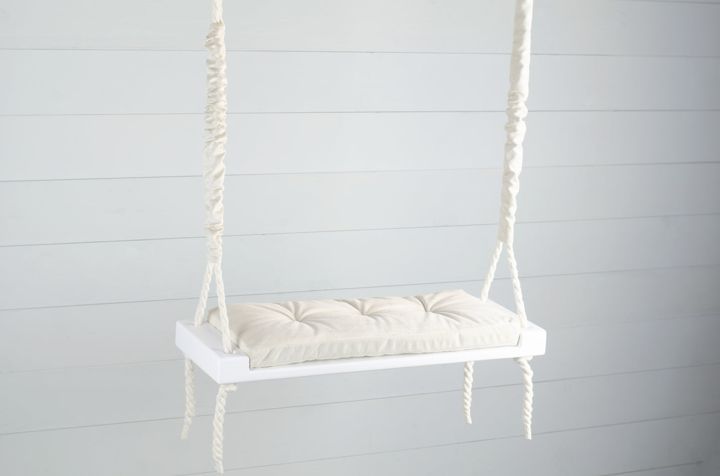 Adult Inside White Swing With A Beige Seat