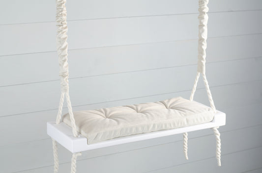 Adult Inside White Swing With A Beige Seat