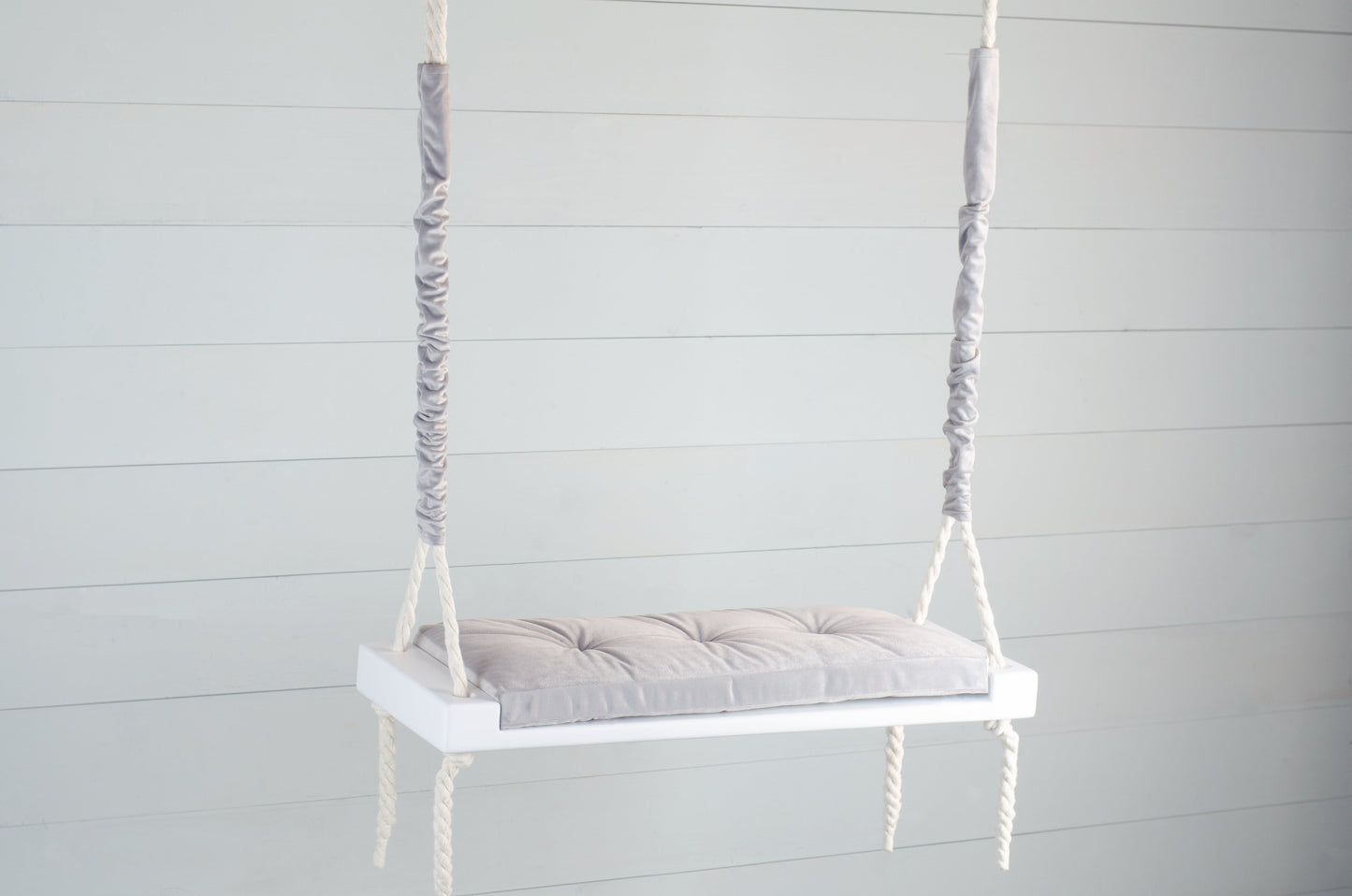 Adult Inside White Swing With A Gray Seat