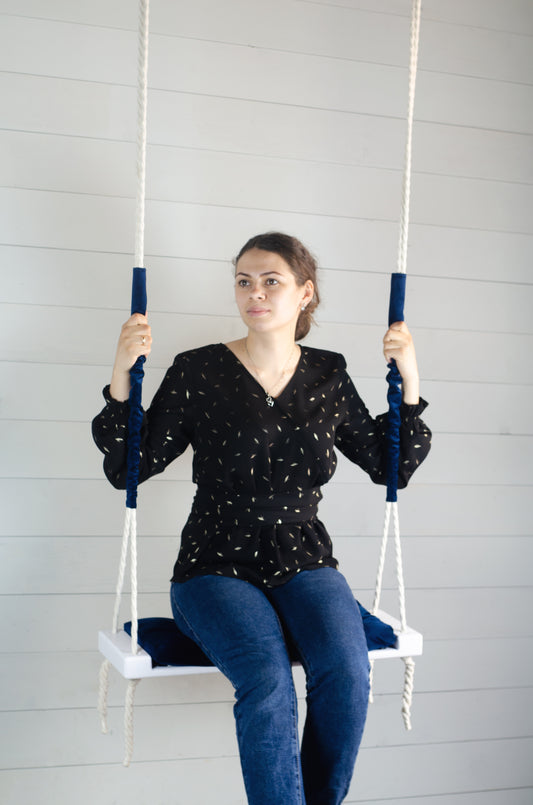 Adult Inside White Swing With A Blue Seat