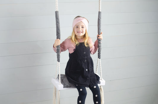 Children Inside White Swing With A Gray Seat